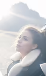 woman looking out car window in the mountains