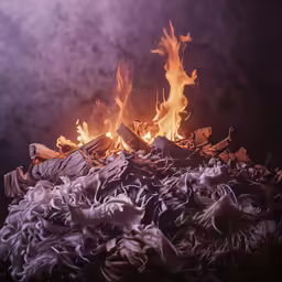 an open fire burning with lots of burned wood