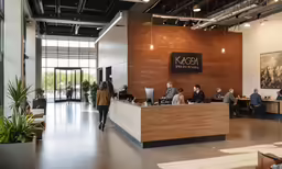 a woman that is walking in a large office building