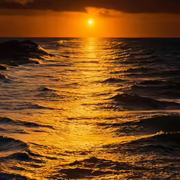 the sun is setting over the ocean waves