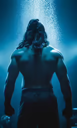 a person with his back turned into a bodysuit and standing under a spotlight