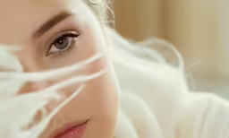 a woman with brown eyes looking at the camera