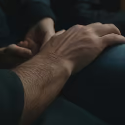 two people hands reaching towards each other