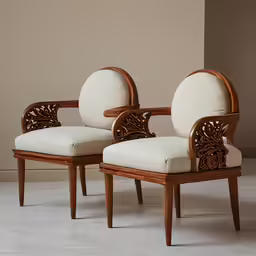 pair of armchairs with carved details and seats