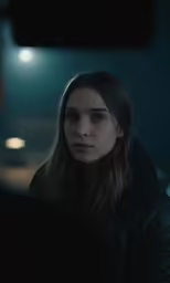 a woman is sitting in front of her reflection