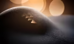 a bunch of silver triangles on top of a black stone
