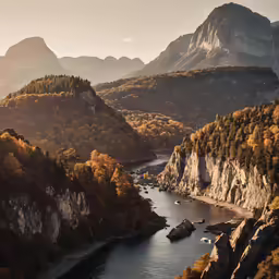 a mountain with a river flowing next to it and other mountains in the distance