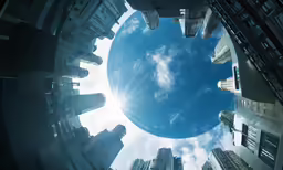 a small round hole with buildings around it