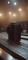 an old camera is on top of a wooden table