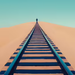 man standing on the top of a train track