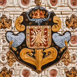 a decorative wall hanging with a fancy crest