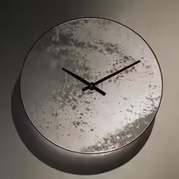 a large clock with a glass frame is pictured