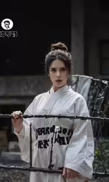 an asian woman is standing behind a fence