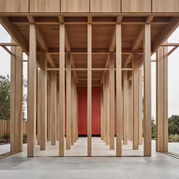 a building with columns and a red door