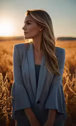 a woman standing in a field with the sun behind her