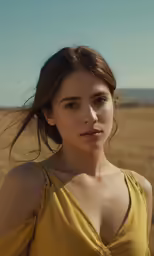 a beautiful young woman standing in the desert