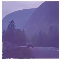 a car driving on a foggy mountain road