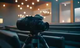 a close up of a camera on a tripod with lights