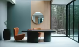 a table with orange chairs in a room