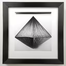a black frame with a drawing of a pyramid