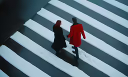 two people in black and red walking on the street