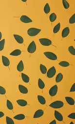 a yellow wall with lots of leaves on it