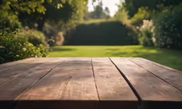 a wooden table in a yard with lots of grass