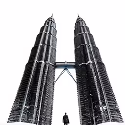 two tall buildings in the middle of a city