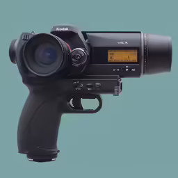a small camera attached to the side of a black gun