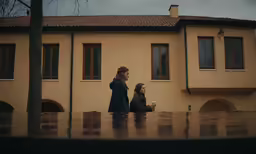 a couple of people that are by some buildings