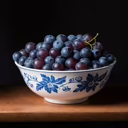 a bowl filled with a blue grape filled bowl