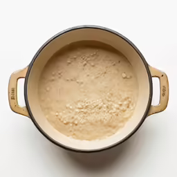 a pot filled with brown liquid on top of a table