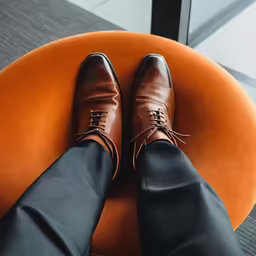 the legs of a person wearing black pants and shoes