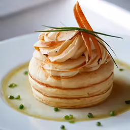 a cream pastry with a little green sprig of chives