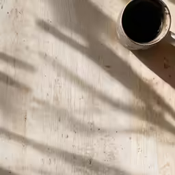 a small mug and a knife on the table