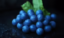 a pile of grapes sitting on top of a table
