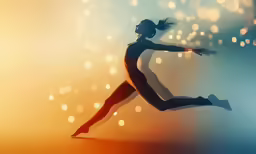 a female dancer in silhouette dancing on an abstract light background