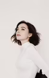 an attractive young woman in a white shirt