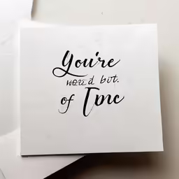 two pieces of paper with black lettering on it