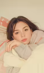 a woman is laying in a bed looking to the side