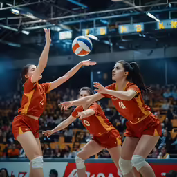 volleyball player in red and yellow blocking ball
