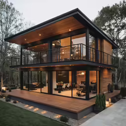 a large house with large windows and balcony at twilight