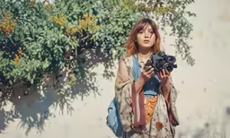 woman in kimono and holding an object and camera