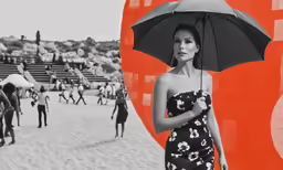 a woman in black and white holds a large umbrella