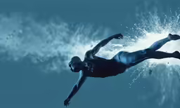 a man swimming in the ocean surrounded by sea sprays