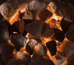 many rocks and lit torches in the middle of them