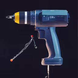 an old style air drill with a chain attached