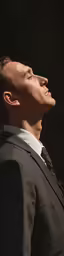 a man wearing a suit and white shirt
