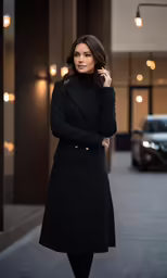 a woman in black standing on the street