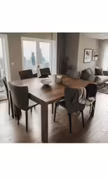 a modern wooden table in front of large windows